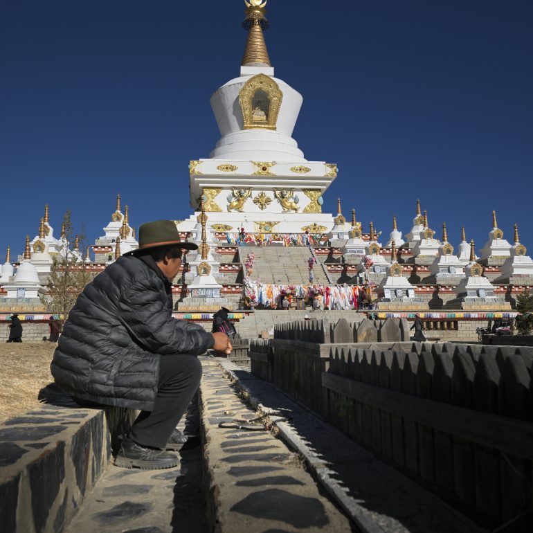 Sitting by the prayer wheels, I feel the spiritual energy of the high plateau in LiTang.